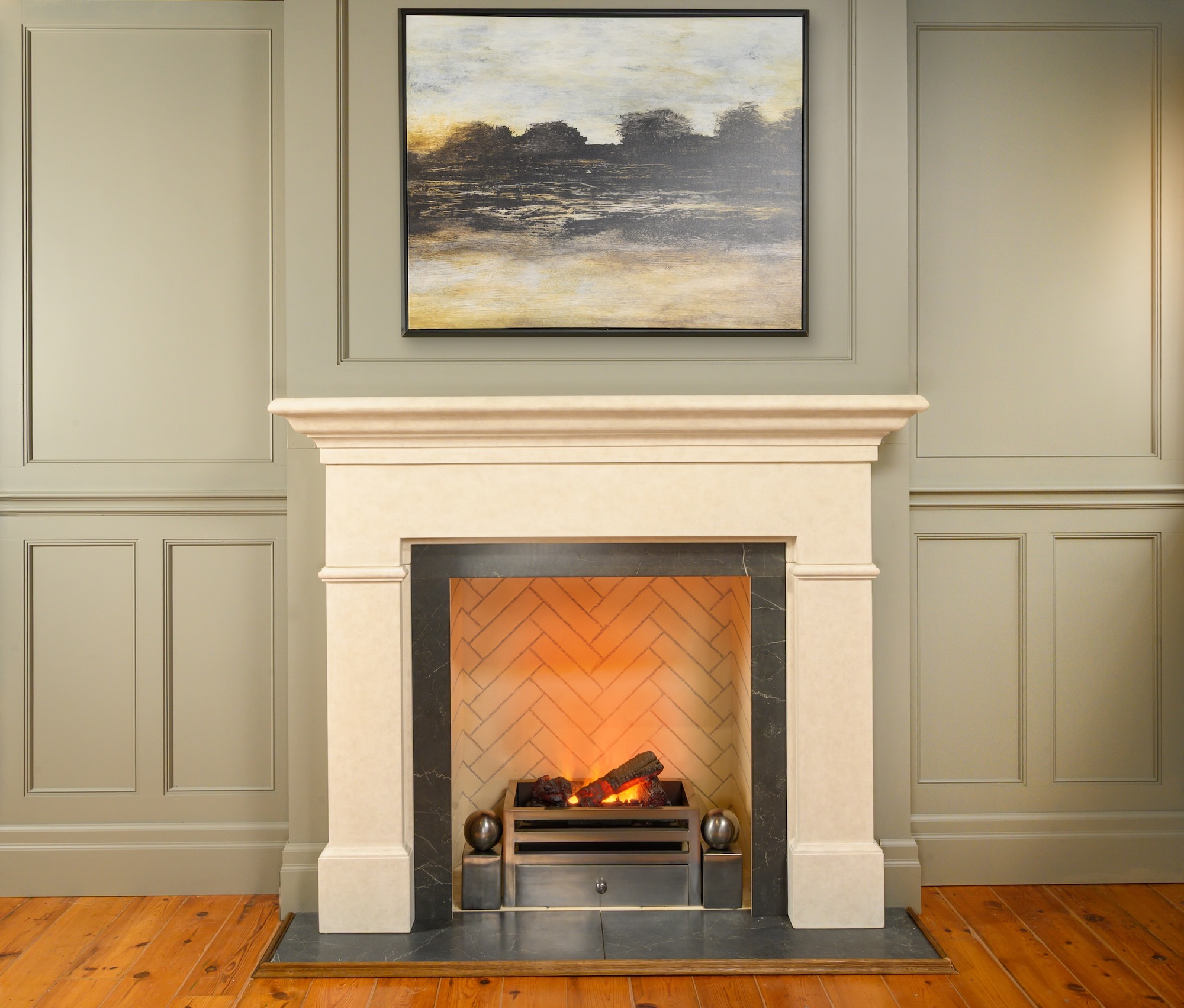 A traditional cast iron fireplace with an electric fire unit, showcasing the perfect blend of classic design and modern technology.